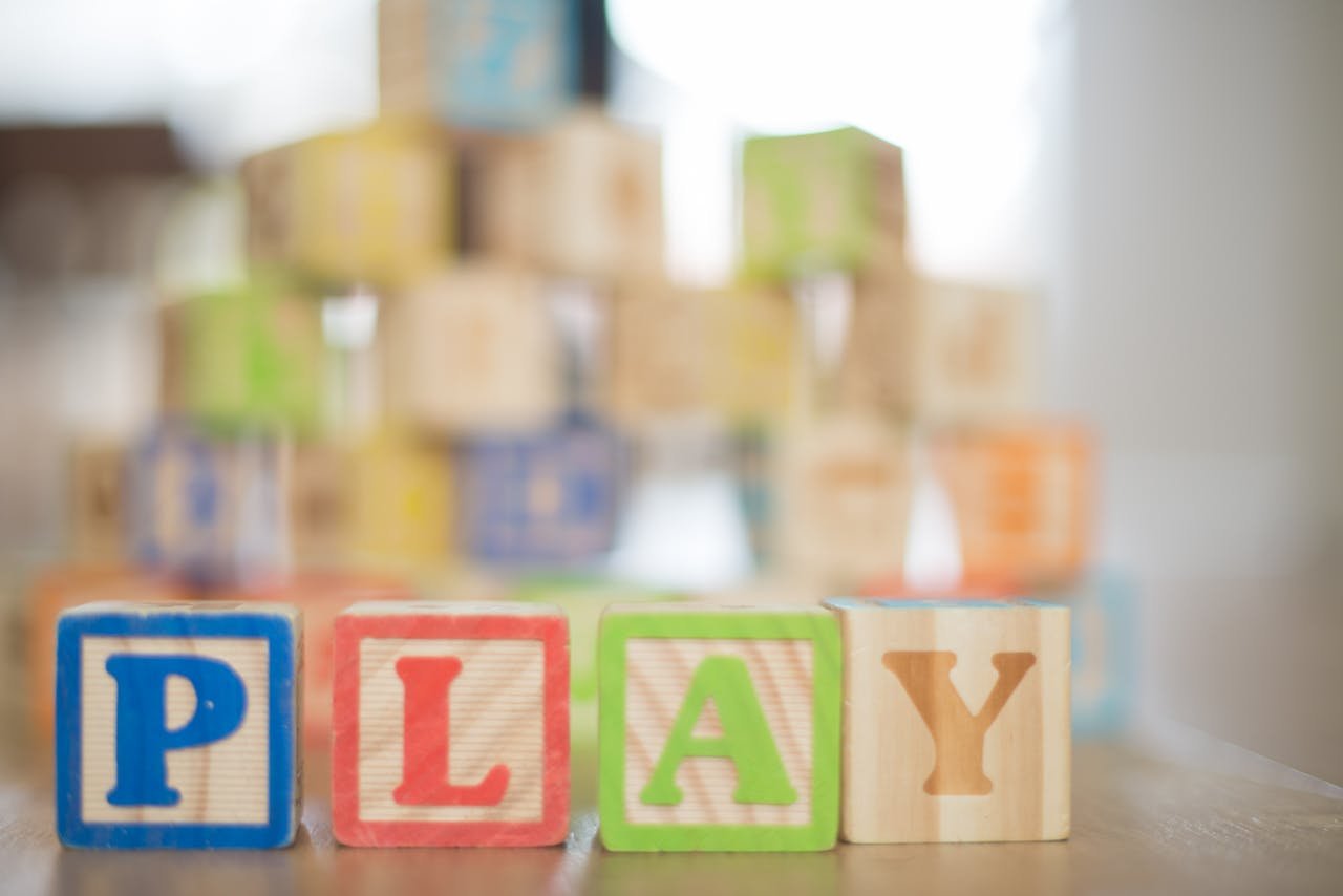 Close-up of colorful wooden blocks spelling 'PLAY', perfect for educational themes.